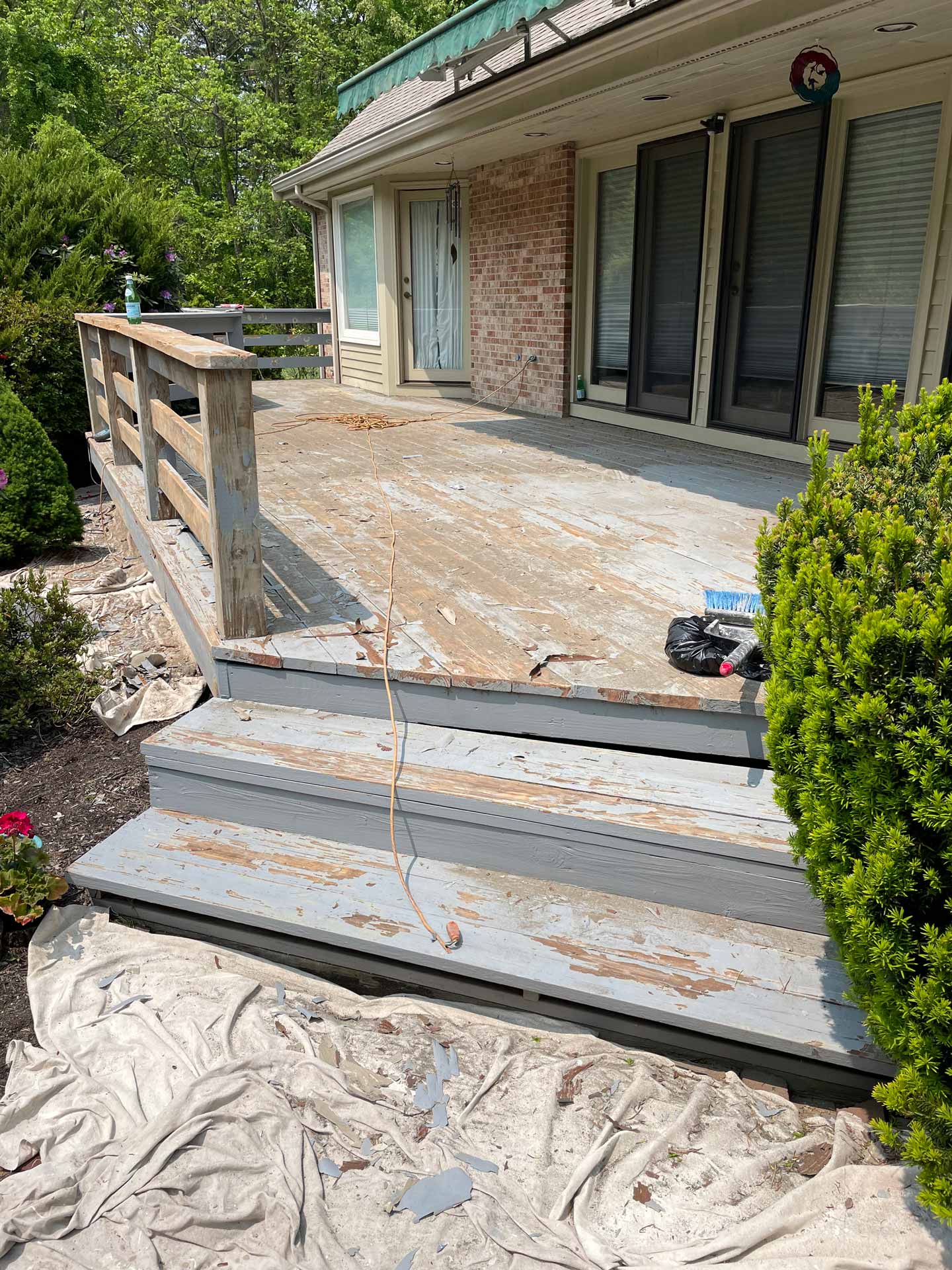 An old, dirty deck with chipped grey paint