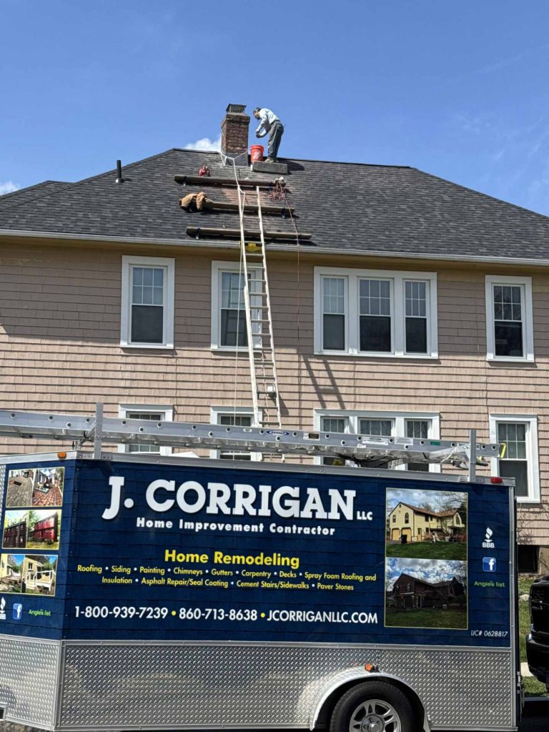 Home improvement contractor from J. Corrigan, LLC working on a roof
