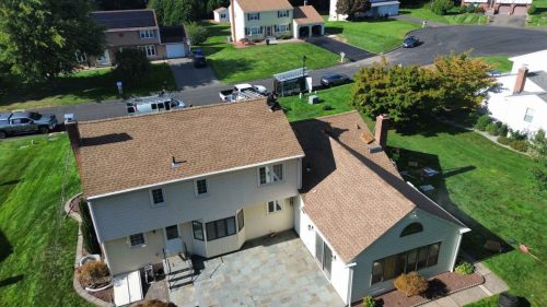 Drone shot of home with newly repaired roof by J Corrigan, LLC