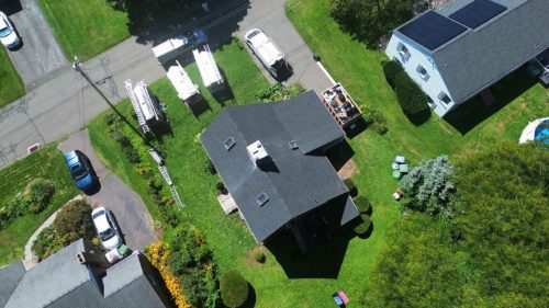 Drone shot of home with newly repaired roof by J Corrigan, LLC