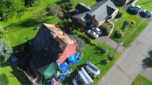 Drone shot of in-progress roof repair on Farmington Valley home